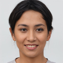 Joyful asian young-adult female with medium  brown hair and brown eyes