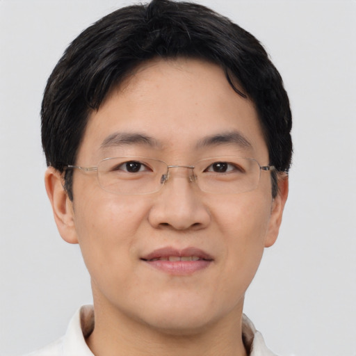 Joyful asian adult male with short  brown hair and brown eyes