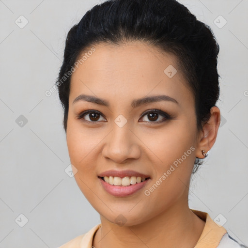 Joyful latino young-adult female with short  brown hair and brown eyes