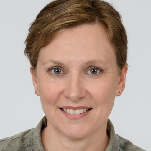 Joyful white adult female with short  brown hair and grey eyes