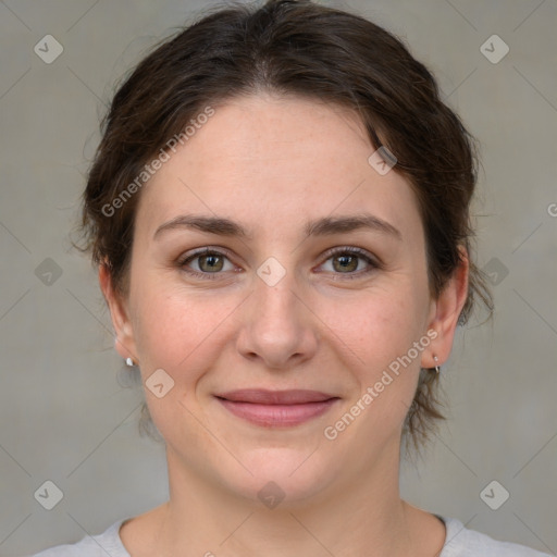 Joyful white young-adult female with medium  brown hair and green eyes