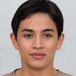 Joyful latino young-adult male with short  brown hair and brown eyes