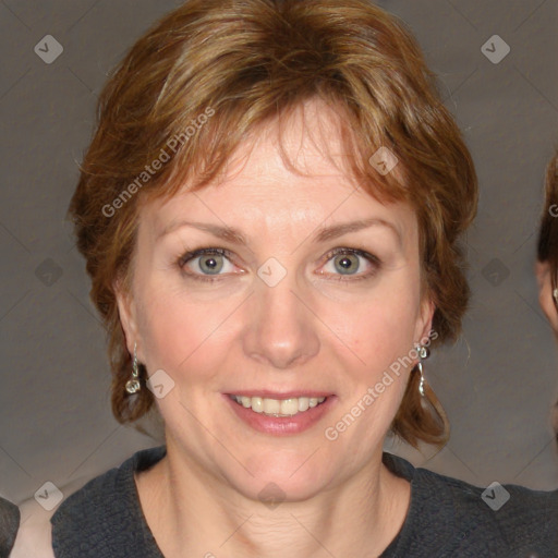 Joyful white adult female with medium  brown hair and blue eyes