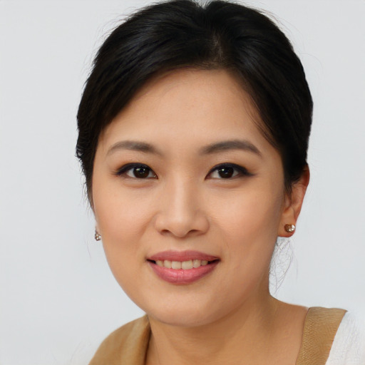 Joyful asian young-adult female with medium  brown hair and brown eyes