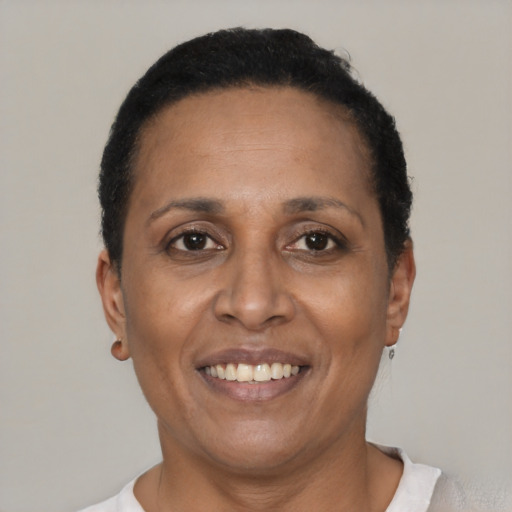 Joyful latino adult female with short  black hair and brown eyes