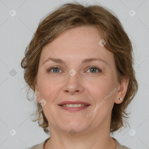 Joyful white adult female with medium  brown hair and grey eyes