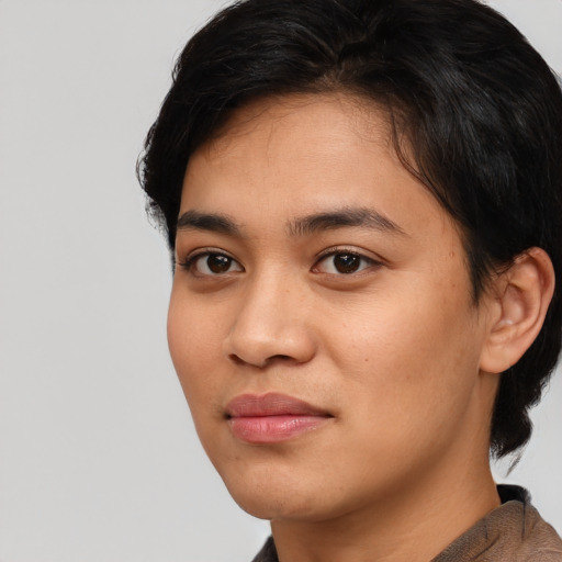 Joyful asian young-adult female with medium  black hair and brown eyes