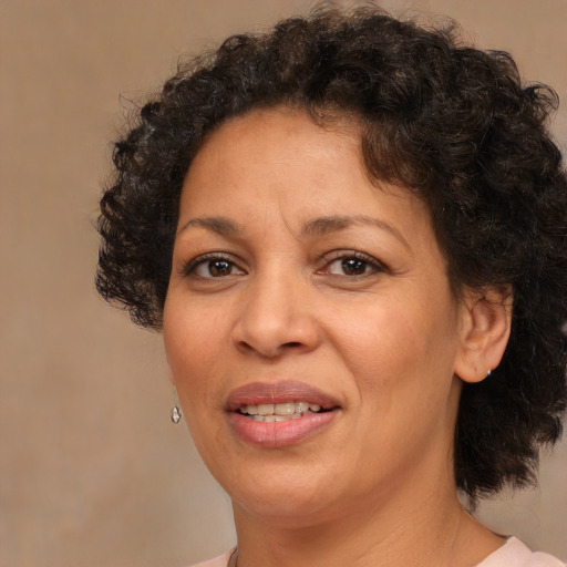 Joyful black adult female with short  brown hair and brown eyes