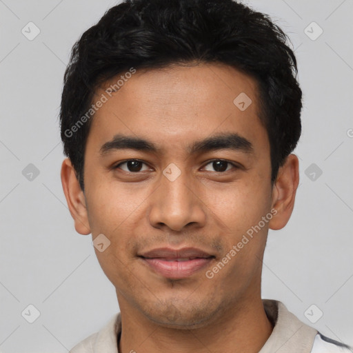 Joyful latino young-adult male with short  black hair and brown eyes