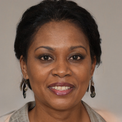Joyful black adult female with medium  brown hair and brown eyes