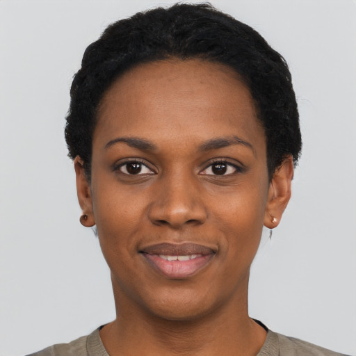 Joyful black young-adult female with short  black hair and brown eyes
