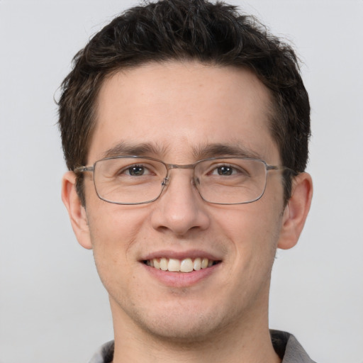 Joyful white adult male with short  brown hair and brown eyes