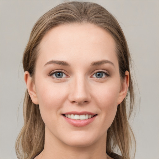 Joyful white young-adult female with medium  brown hair and grey eyes