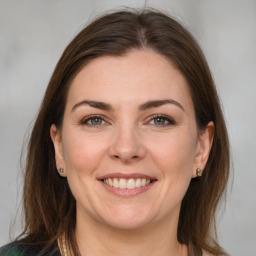 Joyful white young-adult female with medium  brown hair and grey eyes