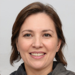 Joyful white adult female with medium  brown hair and brown eyes