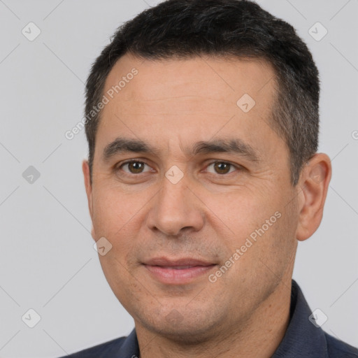 Joyful white adult male with short  brown hair and brown eyes