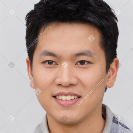 Joyful asian young-adult male with short  brown hair and brown eyes