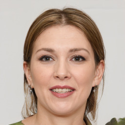 Joyful white young-adult female with medium  brown hair and green eyes