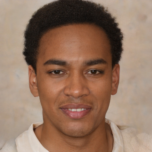 Joyful latino young-adult male with short  brown hair and brown eyes