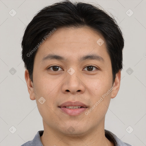 Joyful asian young-adult male with short  brown hair and brown eyes