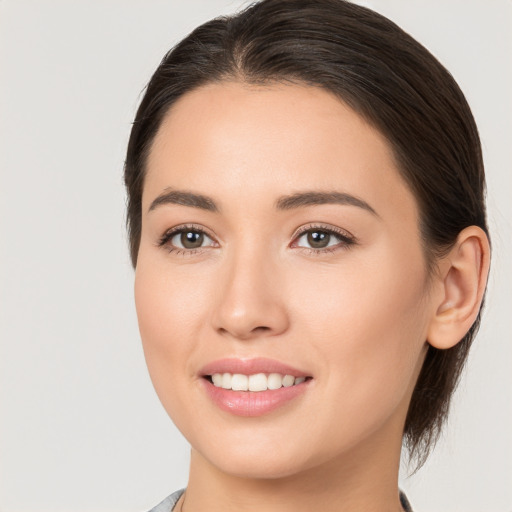 Joyful white young-adult female with medium  brown hair and brown eyes