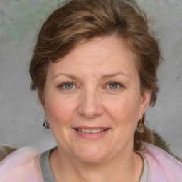 Joyful white adult female with medium  brown hair and grey eyes