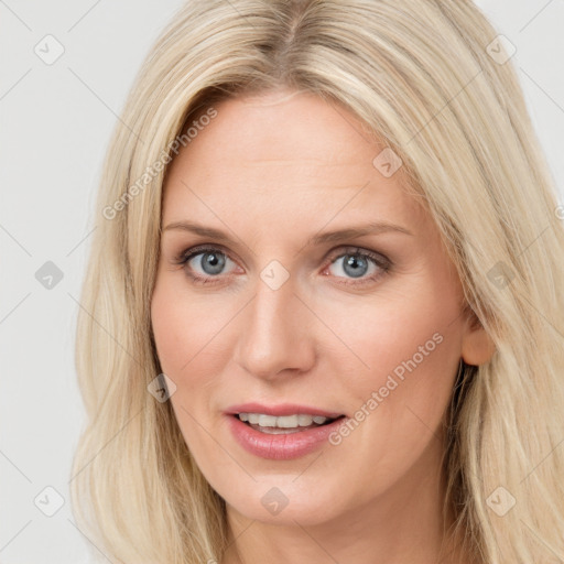 Joyful white young-adult female with long  brown hair and blue eyes