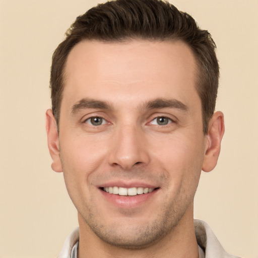 Joyful white young-adult male with short  brown hair and brown eyes