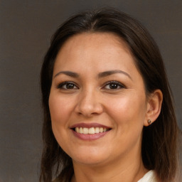 Joyful white adult female with long  brown hair and brown eyes