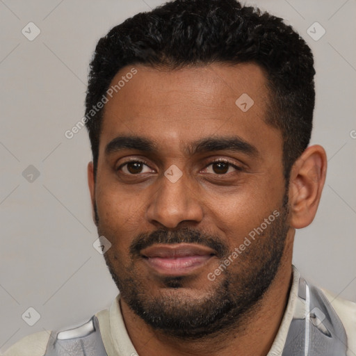 Joyful black young-adult male with short  black hair and brown eyes