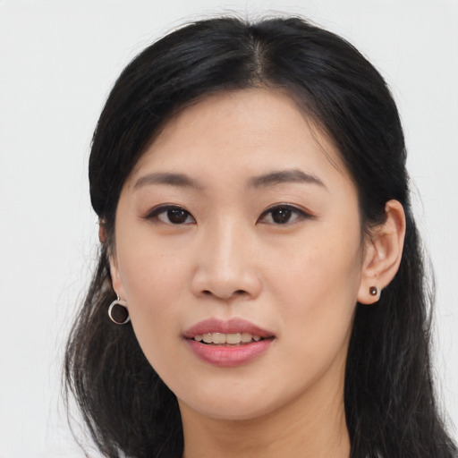 Joyful asian young-adult female with long  black hair and brown eyes
