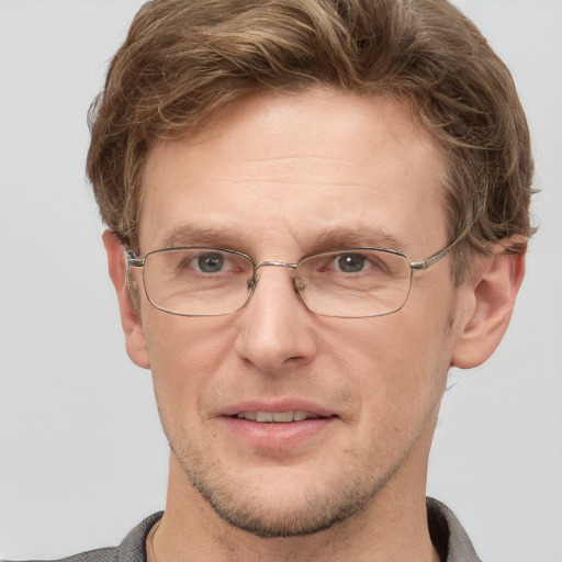 Joyful white adult male with short  brown hair and grey eyes