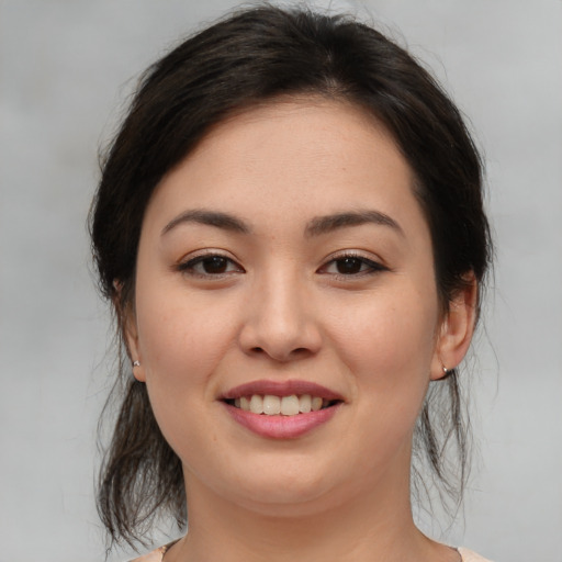 Joyful asian young-adult female with medium  brown hair and brown eyes