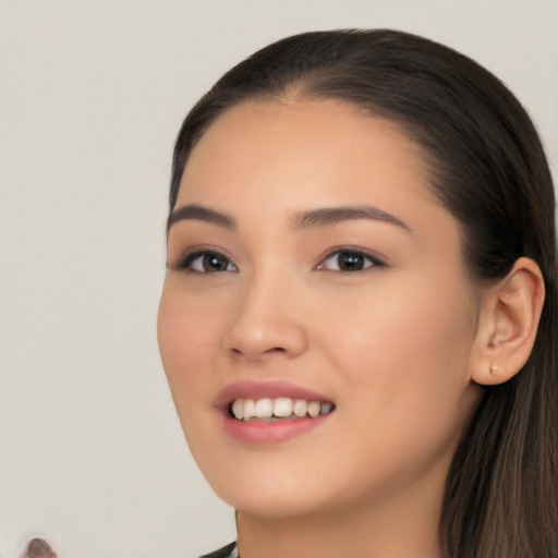 Joyful white young-adult female with long  black hair and brown eyes