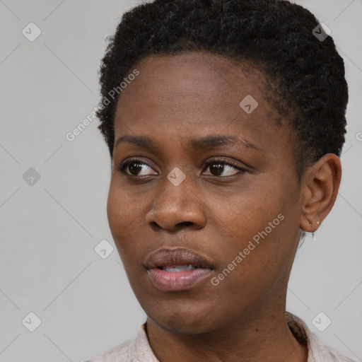 Joyful black young-adult female with short  black hair and brown eyes