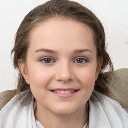 Joyful white child female with medium  brown hair and grey eyes