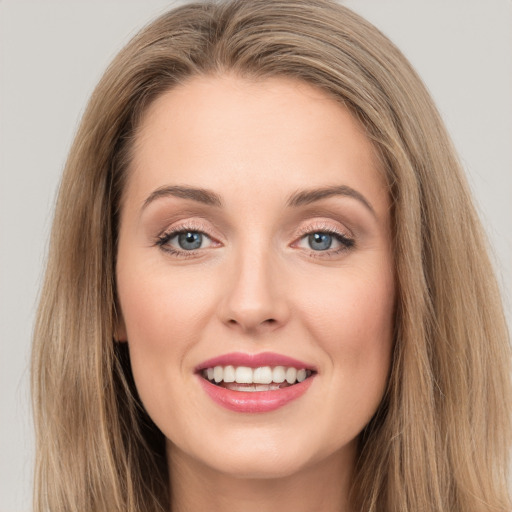 Joyful white young-adult female with long  brown hair and grey eyes