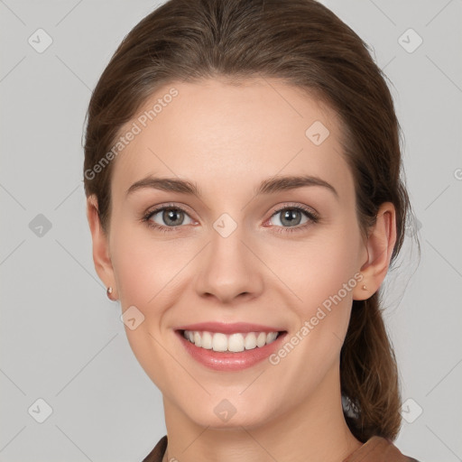 Joyful white young-adult female with medium  brown hair and grey eyes