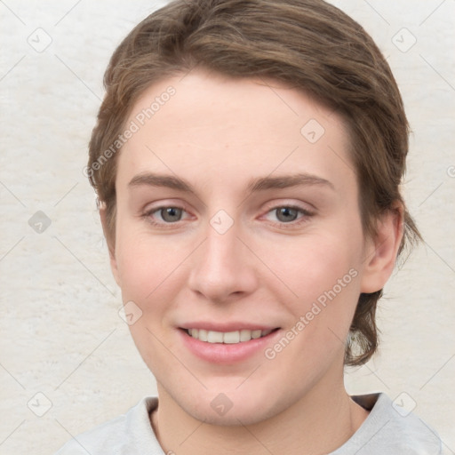 Joyful white young-adult female with short  brown hair and grey eyes