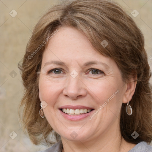 Joyful white adult female with medium  brown hair and blue eyes