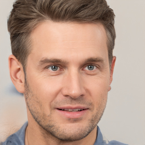 Joyful white adult male with short  brown hair and brown eyes