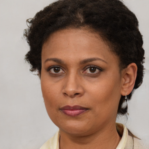 Joyful black adult female with short  brown hair and brown eyes