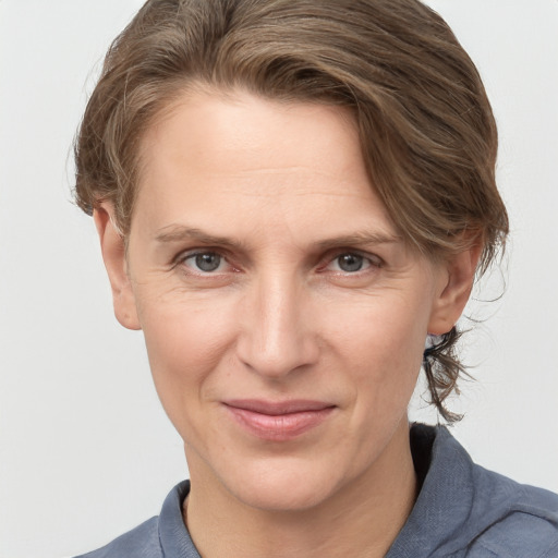 Joyful white adult female with medium  brown hair and grey eyes