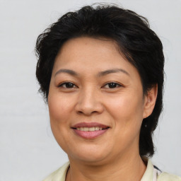 Joyful asian adult female with medium  brown hair and brown eyes