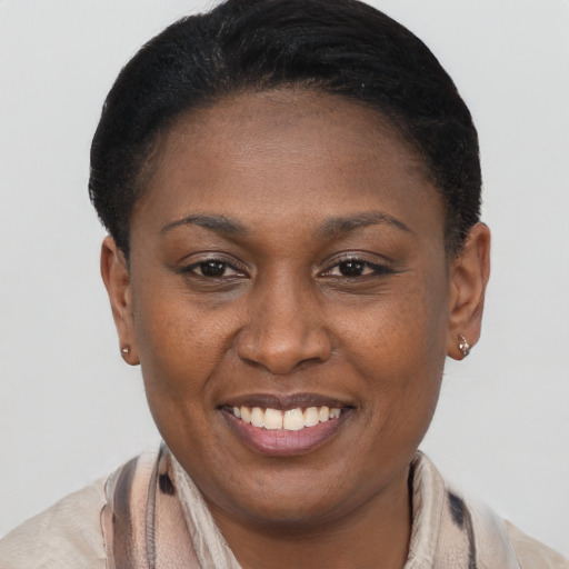 Joyful black adult female with short  brown hair and brown eyes