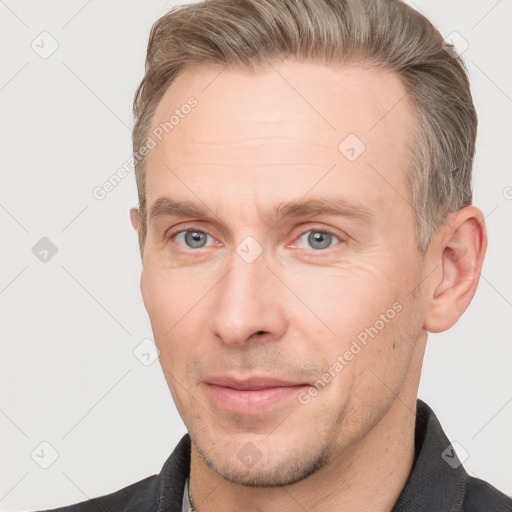 Joyful white adult male with short  brown hair and grey eyes