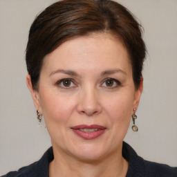 Joyful white adult female with medium  brown hair and brown eyes