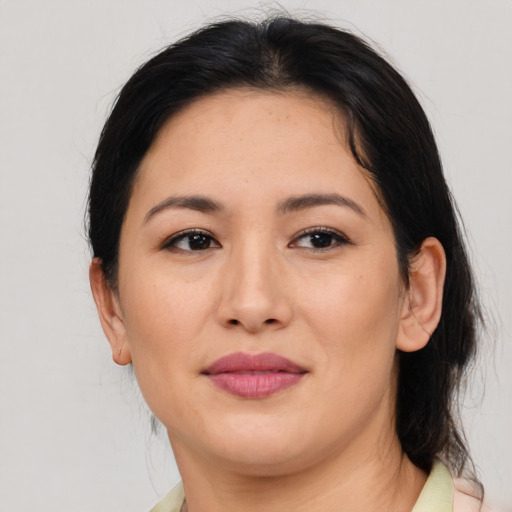 Joyful asian young-adult female with medium  brown hair and brown eyes