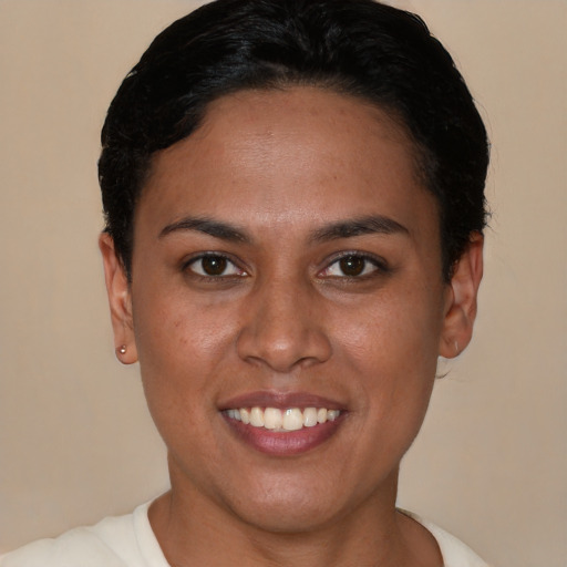 Joyful latino young-adult female with short  black hair and brown eyes