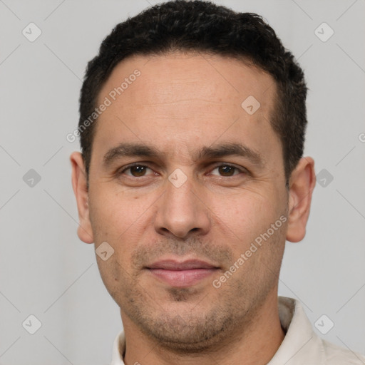 Joyful white adult male with short  black hair and brown eyes